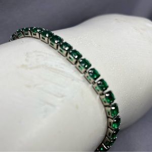 Silver plated tennis bracelet with green cubic zirconia